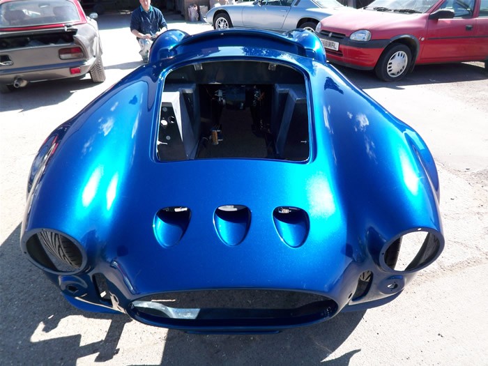 Gloss blue Cobra body outside the workshop
