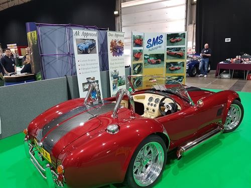 Red Cobra with silver stripes on display at an indoor show