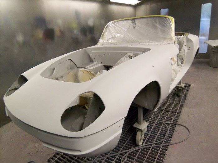 Lotus Elan shell repaired and in white primer on the booth floor