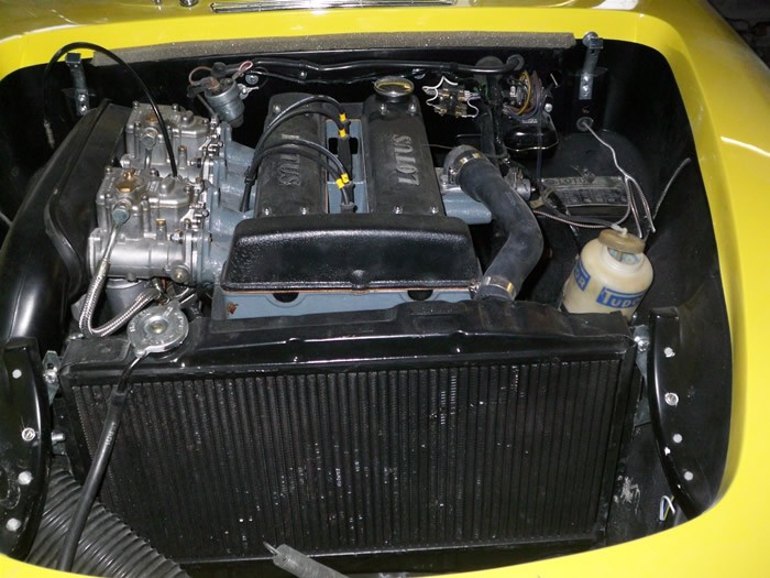 Engine bay of the yellow Lotus Elan