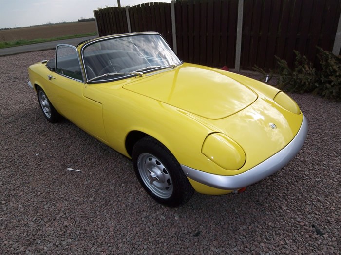 Yellow Lotus Elan S3 drophead with the hood down