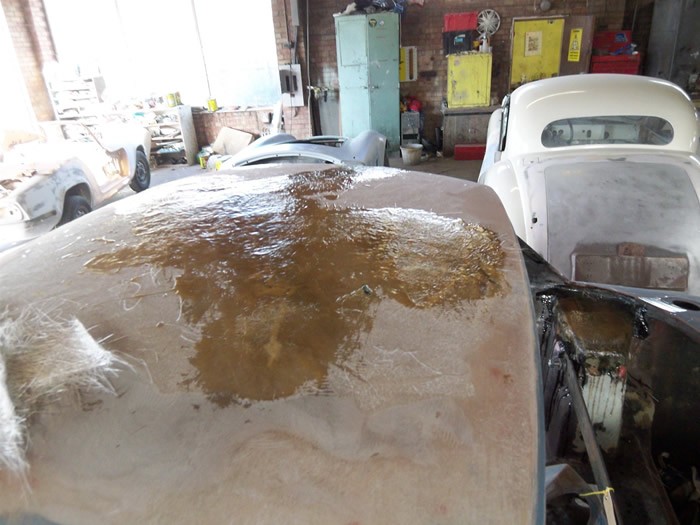 Damaged fibreglass panel stripped back before repair