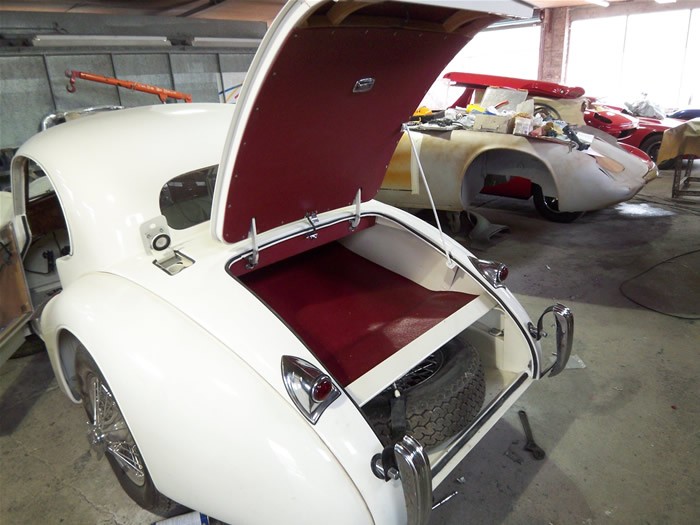 Jaguar XK140 with the boot open showing the red trim