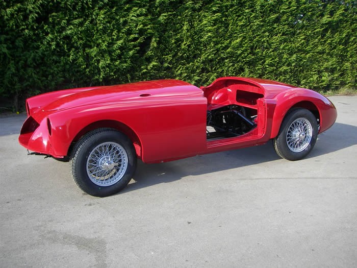 Red open sports car body on wire wheels