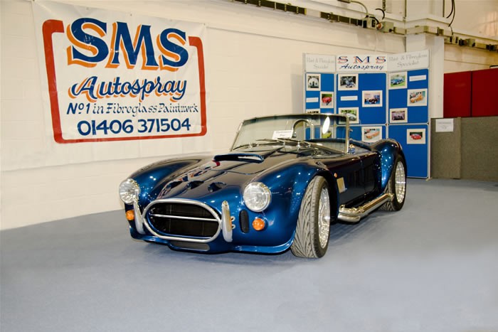 SMS Autospray show stand with the No1 in Fibreglass Paintwork banner and a blue Cobra