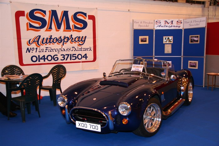 SMS Autospray show stand with a blue Cobra and photo boards